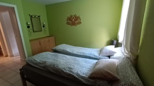 a bedroom with a bed with a mirror and a bed sidx sidx sidx at Home sweet Home in Leichlingen