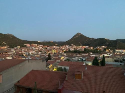 a view of a city with houses and mountains at Luciano Home in Gonnesa