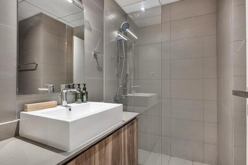 a bathroom with a white sink and a shower at 1BHK Private Apartment - Dreamers Nest in Sharjah Intl