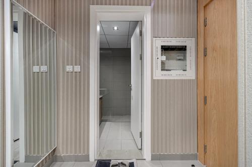 a bathroom with a walk in shower and a microwave at 1BHK Private Apartment - Dreamers Nest in Sharjah Intl