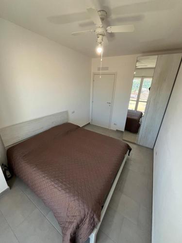 a bedroom with a bed and a ceiling fan at Luciano Home in Gonnesa