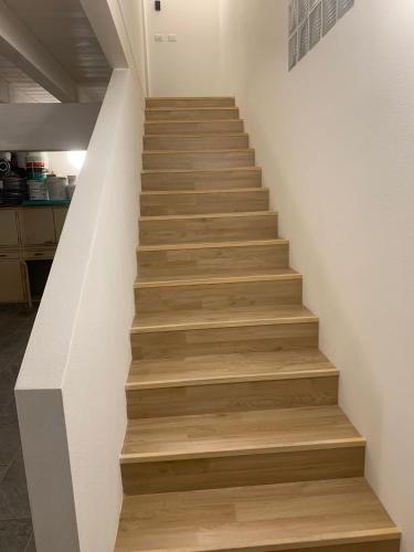 a staircase in a house with wooden floors at Luciano Home in Gonnesa