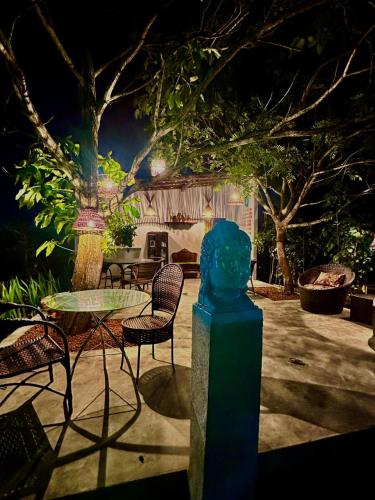a table and chairs in a yard at night at Suíte 1 - Village Capixaba in Gravatá