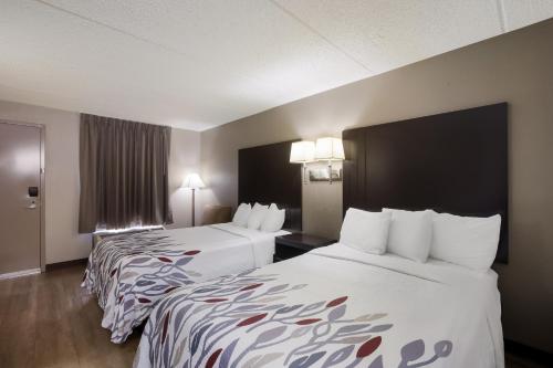 a hotel room with two beds and two lamps at Red Roof Inn Atlanta Airport NE Conley in Conley