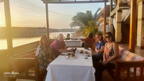 a group of women sitting at a table in a restaurant at Amon guest house in Abu Simbel