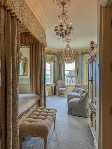 a bedroom with two beds and a chandelier at The Chanler at Cliff Walk in Newport