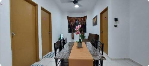 a room with a table with chairs and a vase of flowers at KK Minimalist Budget 2 Bedroom Appt f 6 free park in Penampang