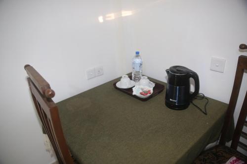 a table in a room with a coffee maker on it at Evergreen Cottage in Ella