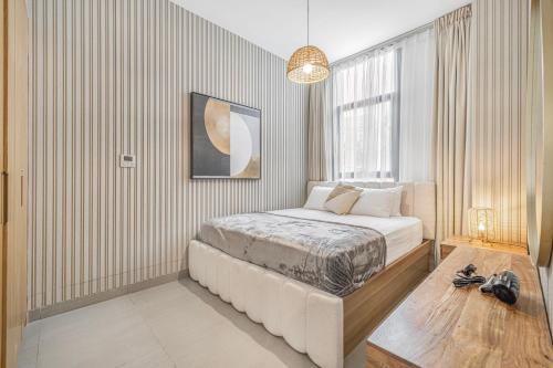 a bedroom with a bed and a large window at 1BR Wow Apartment in Sharjah - Crystal Retreat in Sharjah Intl