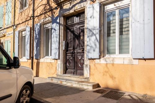 a door of a building with a car parked in front at Chez Yvette 3 WIFI Near the sea in Leucate