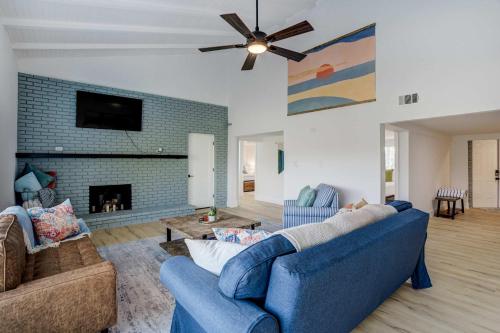 a living room with two blue couches and a fireplace at Riverside Luau Tiki Hut Fire Pit & Outdoor Fun in Bradenton