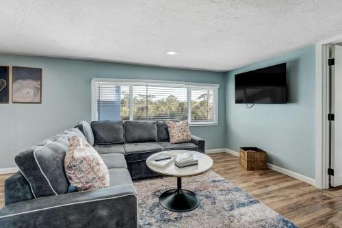 a living room with a couch and a table at Riverside Breeze Tropical Retreat w Tiki Hut&BBQ in Bradenton