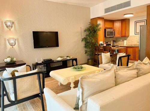 a living room with a couch and a table at Xeliter Balcones del Atlantico - Las Terrenas in Las Terrenas