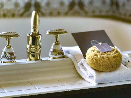 a muffin sitting on a towel next to a sink at The Chanler at Cliff Walk in Newport