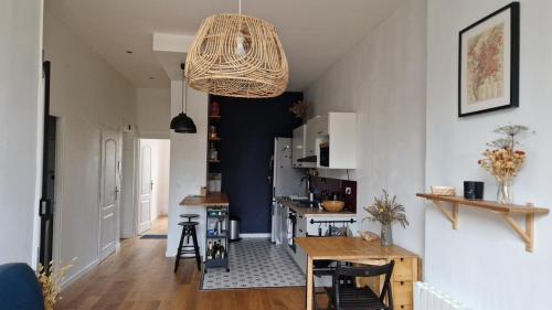 un salon avec une table et une cuisine dans l'établissement Le Philippe, Appartement cosy au cœur de Lyon, 2 chambres, à Lyon
