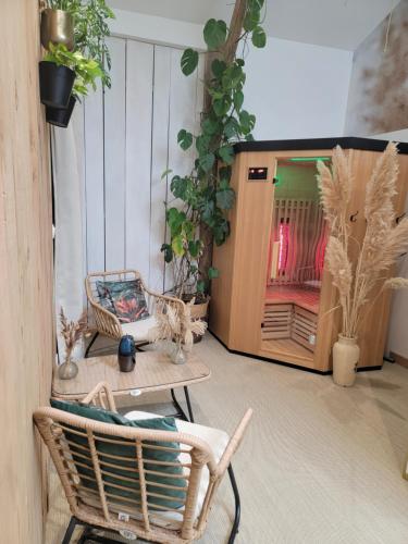a room with chairs and a table and a tv at gîte grange le Kulmino in Notre-Dame-de-Monts