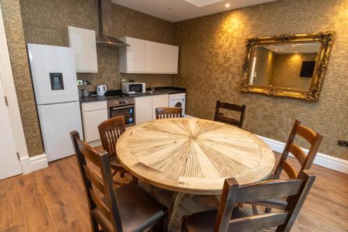 a kitchen with a large wooden table and chairs at The Shankly Hotel in Liverpool