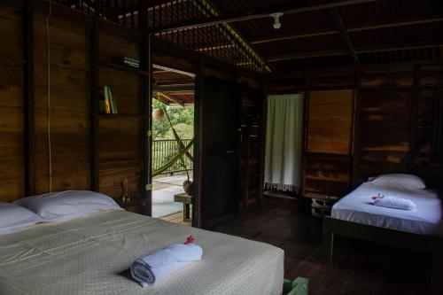 a bedroom with two beds with towels on them at Casa Cielito in Nuquí