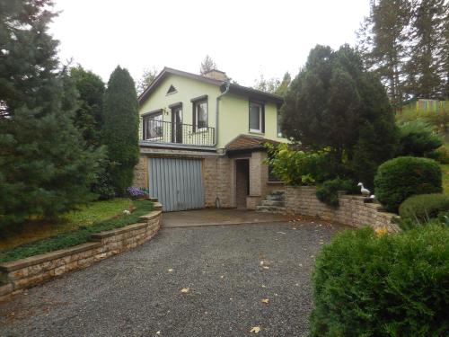 a house with a garage and a driveway at Ferienhaus Am Freibad in Bad Berka
