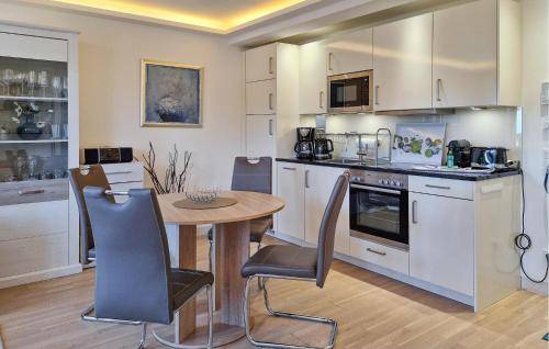 a kitchen with a table and chairs in a room at Princess in Binz