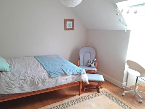 a bedroom with a bed and two chairs at M047 Sattva Carrowholly Westport in Westport