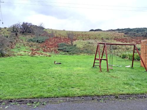a playground in a field with a swing at M047 Sattva Carrowholly Westport in Westport