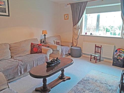 a living room with a couch and a table at M047 Sattva Carrowholly Westport in Westport