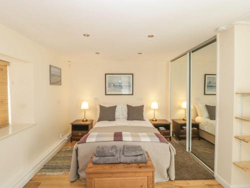 a bedroom with a large bed and two lamps at The Forge in Bath