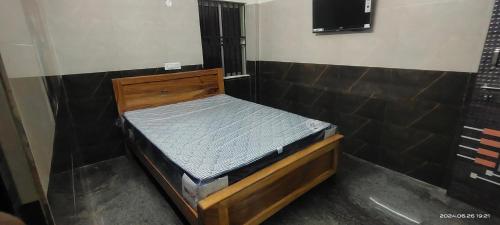 a small wooden bed in a room with at VRSinn in Vishāram