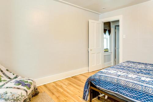 a white bedroom with a bed and a window at 4 Mi to Lake Superior Calumet Getaway! in Calumet
