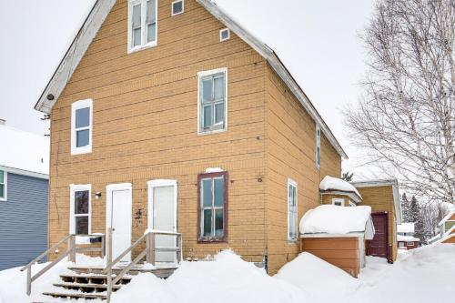 a house with snow in front of it at 4 Mi to Lake Superior Calumet Getaway! in Calumet