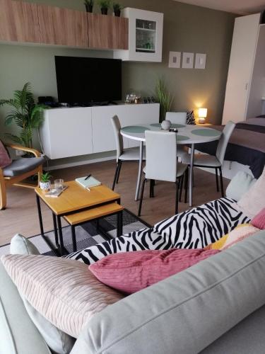 a living room with a couch and a table at Zee en Strand in De Panne