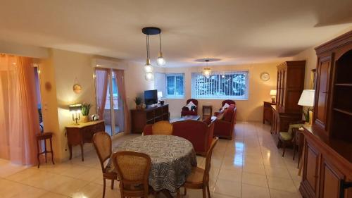a living room with a table and a couch at La terrasse de Jeanne in Millau