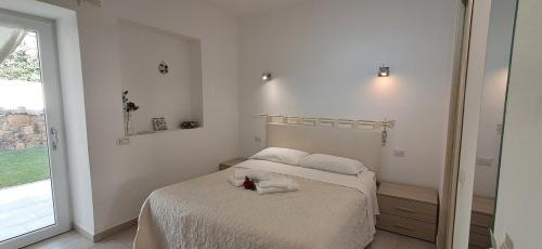 a bedroom with a bed with a flower on it at Al Mare da Francesca in Olbia