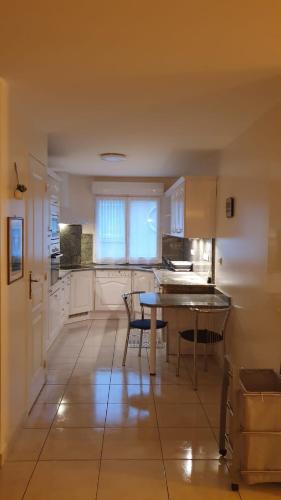 une cuisine avec une table et des chaises dans une pièce dans l'établissement La terrasse de Jeanne, à Millau