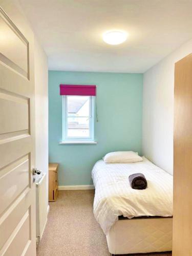 a bedroom with a bed and a window at 3 bed house with parking near airport in Edinburgh
