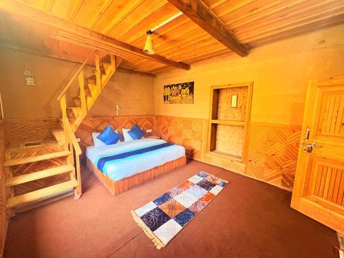 a bedroom with a bed and a staircase in a room at Pine Nest cottages in Jibhi