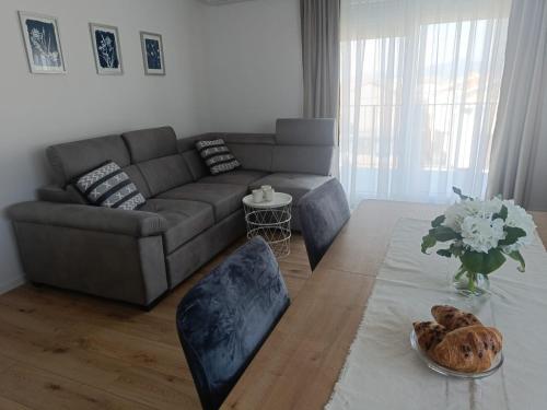 a living room with a couch and a table at Apartman Delta in Metković