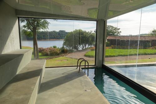 a view of a swimming pool from the inside of a house at Clara Ibiúna Resort in Ibiúna