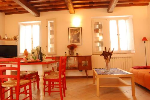 a kitchen and living room with a table and chairs at Stonehouse - Lucca in Capannori