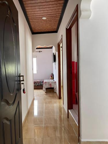 a hallway with a door and a table in a room at Casa Abdou in Chefchaouene