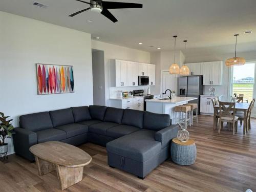 a living room with a blue couch and a kitchen at Hideaway in Freeport