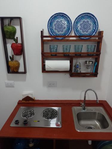 a kitchen with a sink and plates on a wall at Sunzal Refugio Perfecto-3 in El Sunzal