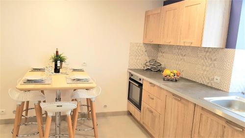 - une cuisine avec une petite table et un évier dans l'établissement Didalie locations lavande, à Sainte-Maxime