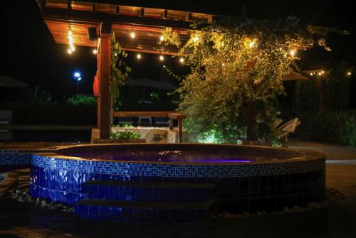 a pool in the middle of a yard at night at Hotel El Cielo en la Tierra in Quimbaya