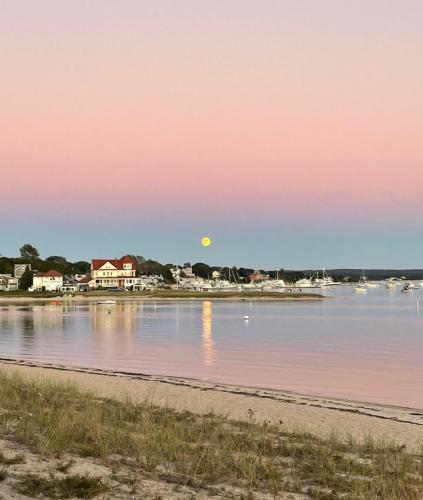 a sunset over the water at the beach at 41 East Boulevard Onset- The Glam Shack in Onset