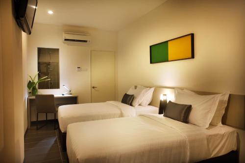 Säng eller sängar i ett rum på O'Boutique Suites Hotel @ Bandar Utama