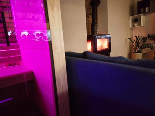 a room with purple lighting and a fireplace at Apartment Keleia in Celje