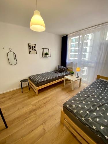 a room with a bed and a table in it at Warszawa Centrum Pokoje in Warsaw