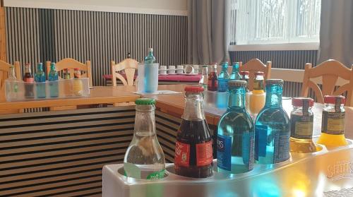 a table with many bottles of alcohol on it at Hotel Wippertal - voll klimatisiert in Bernburg